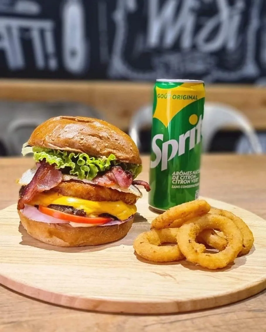 Menu burger, onion rings et soda servi sur planche au restaurant